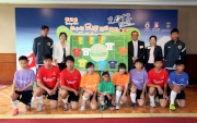 The Cluba?s Executive Manager, Charities, Florine Tang (back row, 2nd right) joins HKFA Chairman Brian Leung (back row, 3rd right); Leisure and Cultural Services Assistant Director (Leisure Services) Olivia Chan (back row, 2nd left) and the Programmea?s ambassadors Tsang Kam-to (back row, 1st left) and Lau Cheuk-hin (back row, 1st right) and young footballers at the kick-off ceremony.