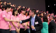 The Cluba?s Executive Director, Charities, Douglas So, shakes hand with secondary students at the press conference. 