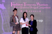 The Cluba?s Executive Manager, Charities, Florine Tang (right) presents the award to the first runner- up of the a?FashionaᡱTerracotta Warriors Inspired Fashion Design Competitiona? Daphney Ho (centre).