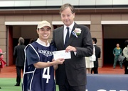 Before the race, Charles Villoz, Vice President and Head of International Sales of LONGINES International, presents a HK$2,000 prize to the Stables Assistant responsible for Packing Whiz, the best turned out horse in the LONGINES Jockey Club Cup.