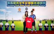 The Cluba?s Head of Charities Projects Rhoda Chan (left) congratulates all the graduates who have completed the training and presents the Manchester United football shirt to one of the winners, Robert Wong (right).
