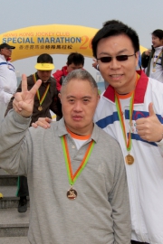 Tang Chi-wah (left) and his pair-up runner Lester Lam (right), one of the CARE@hkjc Volunteer Team members, finish the 3 km run.