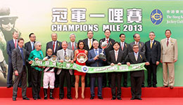 Mr T Brian Stevenson, Chairman of HKJC; Club Stewards; Mr Winfried Engelbrecht-Bresges, CEO of HKJC; and the winning connections of Dan Excel smile for cameras at the Champions Mile trophy presentation ceremony.