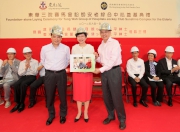 Club Steward Anthony W K Chow (right) receives a souvenir from Chief Secretary for Administration Carrie Lam (centre) together with Secretary for Labour and Welfare Matthew Cheung (left).  